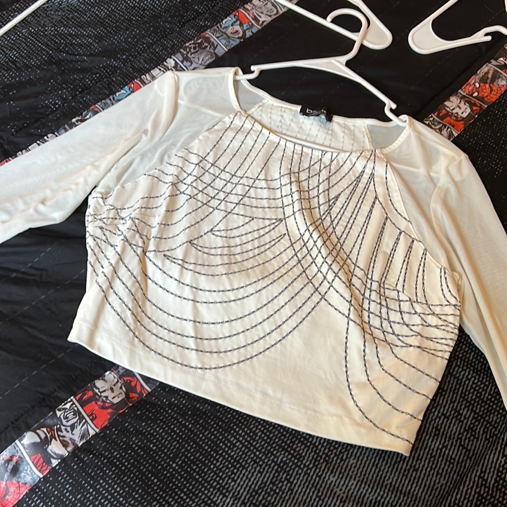 Bebe white crop top festive shirt. See through sleeves perfect for a night out!